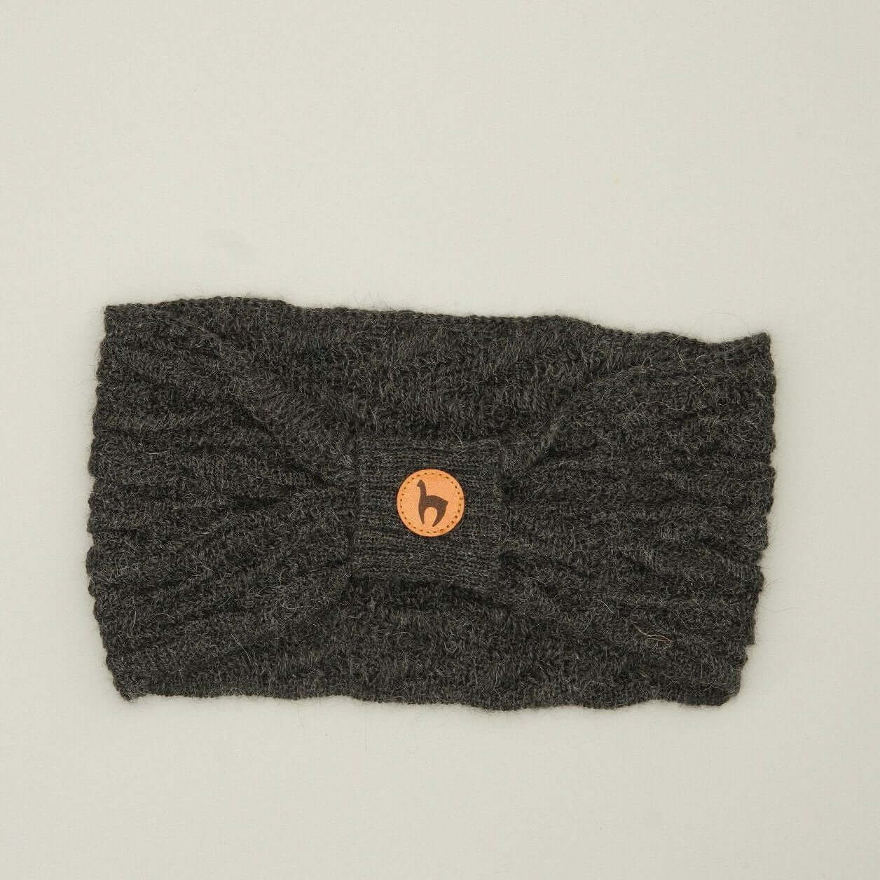 Alpaka Stirnband kaufen für Damen aus 100% Babyalpaka in dunkelgrau mit Knotendetail.
