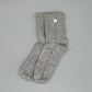 Bio Alpaka Socken aus grauer Alpakawolle mit Alpaka-Stickerei auf dem Bündchen.